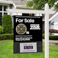 a for sale sign in front of a house